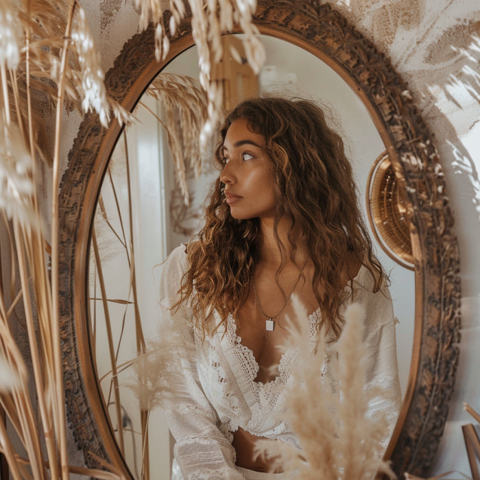 woman with boho vibe decor looking into mirror to say a positive affirmation