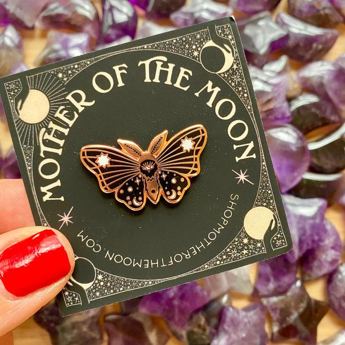Moon Moth Enamel Pin with purple amethyst crystals in background
